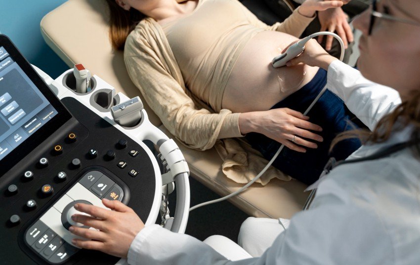 Pregnant woman receiving an ultrasound examination from a gynecologist during prenatal care