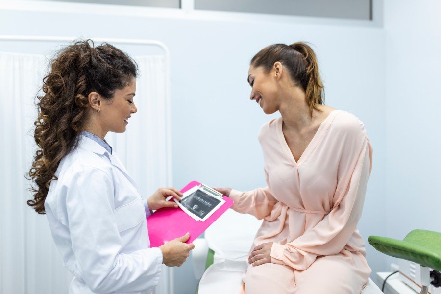 Gynaecologist consulting a woman about her reproductive health