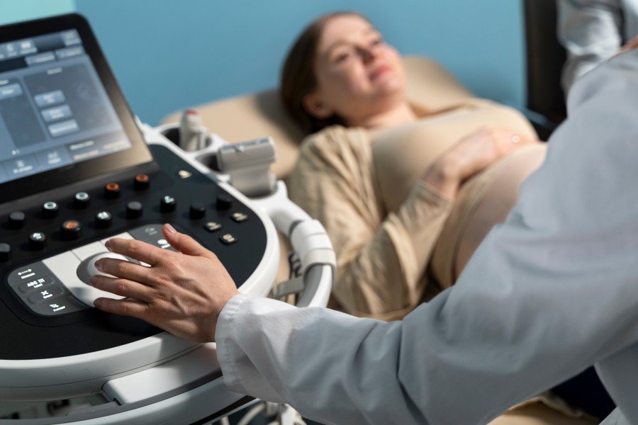 Pregnant woman undergoing an ultrasound examination during antenatal care