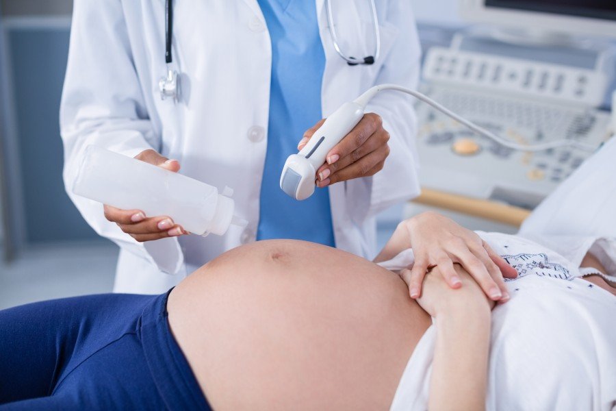 Pregnancy care specialist performing an ultrasound scan on a pregnant woman